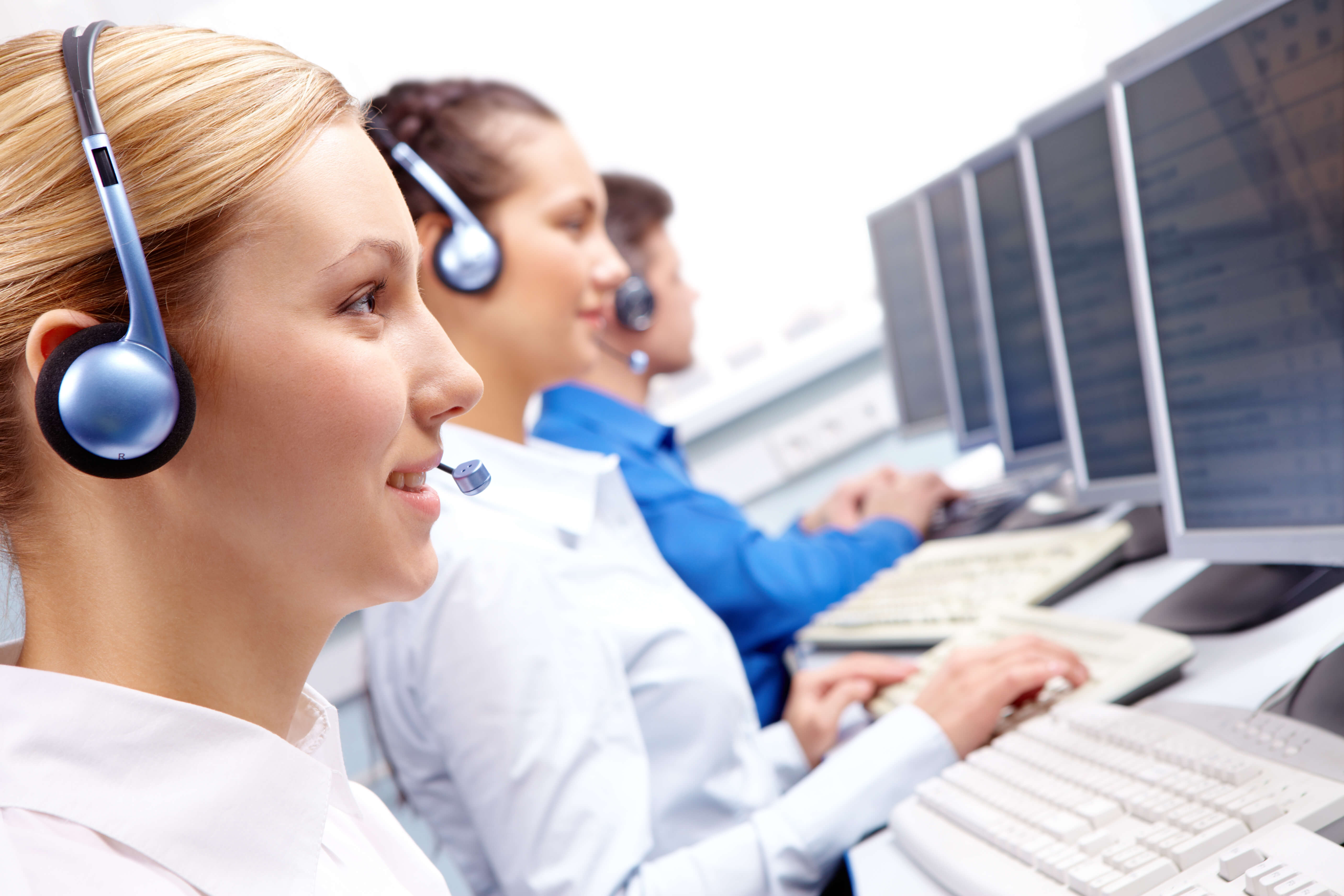 Call center agents working at computers.